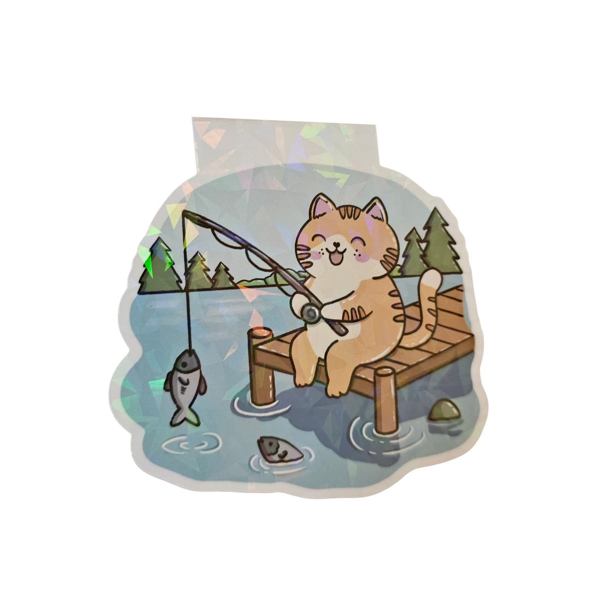 Magnetische Lesezeichen mit dem Motiv einer Rotbraunen Katze. Sie angelt an einem See nach Fischen mit einer Angel.